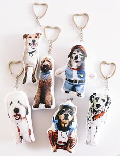 several key chains with dogs on them are hanging from the same length as each other