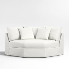 a white couch with four pillows on it