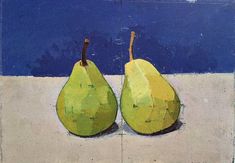 two green pears sitting on top of a cement slab next to a blue wall