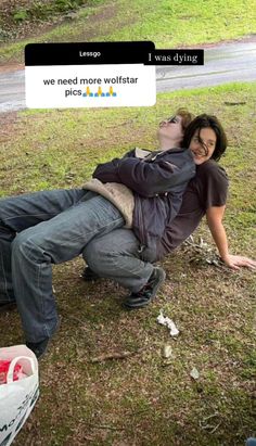 a man and woman laying on the ground with their arms around each other