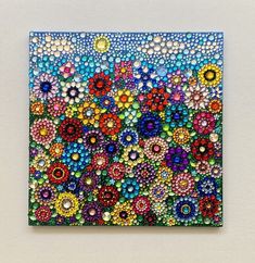 a colorful painting with lots of bubbles on it's surface and flowers in the middle