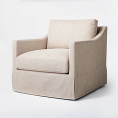 a beige chair sitting on top of a white floor