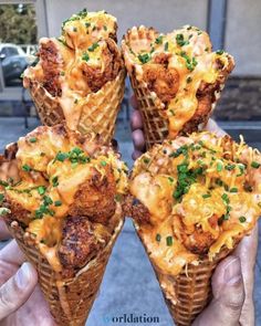 four waffle cones filled with different types of food on top of eachother