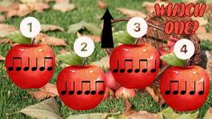 four apples with musical notes on them sitting in the grass