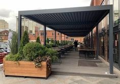 an outdoor covered patio with tables and chairs