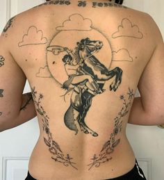 the back of a woman's body with tattoos on her upper and lower back