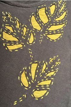 a t - shirt with yellow leaves on it