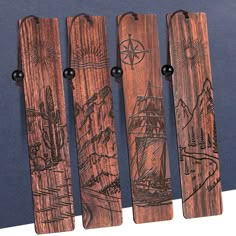 four wooden bookmarks with drawings on them