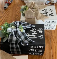 some books are wrapped in burlap and tied with ribbon on the floor next to scissors