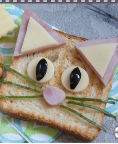 a piece of bread with cheese and eyes on it