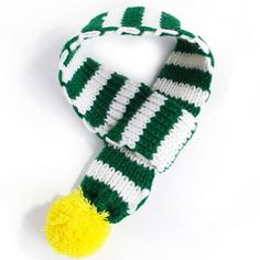 a green and white knitted scarf with a yellow pom - pom