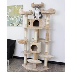 a cat sitting on top of a scratching tower