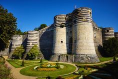 an old castle with a garden in the middle