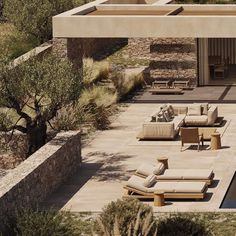 an outdoor living area with couches and tables next to a pool in the desert