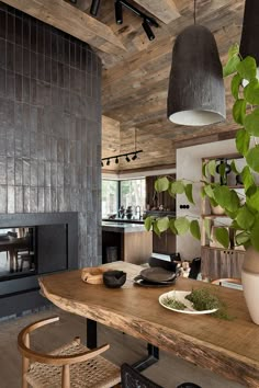 a wooden table sitting in front of a fire place next to a potted plant