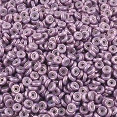 purple seed beads are shown on a white surface