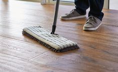 a person is cleaning the floor with a mop