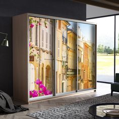 a living room with an open sliding door that has flowers painted on the glass doors