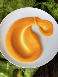 a white plate topped with an orange sauce