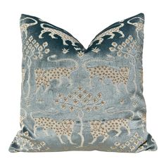 a blue and gold pillow with elephants on the front, sitting on a white background