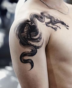 a man with a dragon tattoo on his arm