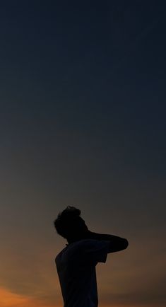 a man standing on top of a beach next to the ocean