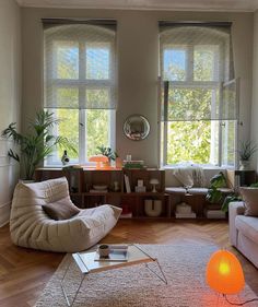 a living room filled with furniture and lots of windows