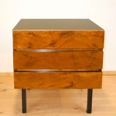 a wooden dresser sitting on top of a hard wood floor