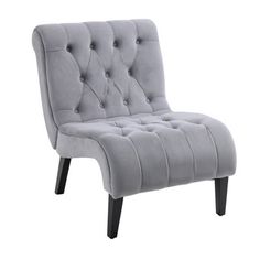 the grey chair is upholstered with buttons