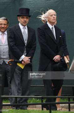 three men in suits and hats are walking together