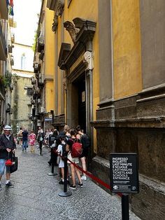 many people are walking down the narrow street