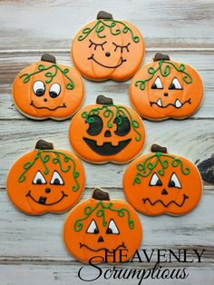 decorated cookies with faces and vines on them are arranged in the shape of pumpkins