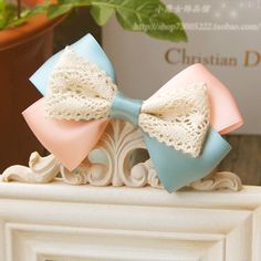 a close up of a bow tie on top of a white fireplace mantel next to a potted plant