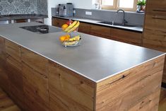 a bowl of fruit sitting on top of a kitchen counter