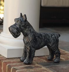 a statue of a dog standing next to a pillar