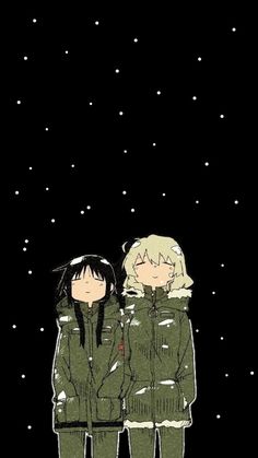 two people standing next to each other in front of the night sky with snow falling on them