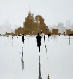 two people are walking in the snow with buildings behind them