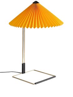 a yellow umbrella lamp sitting on top of a table