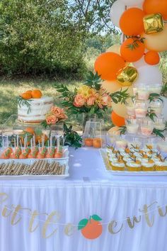 an orange and white dessert table with balloons