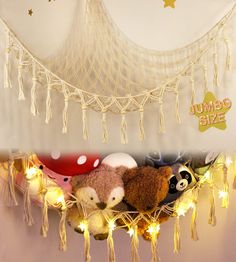 several stuffed animals are sitting in a hammock with string lights hanging from the ceiling