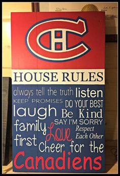 a sign that says house rules on the side of a building in red, white and blue