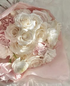 a bouquet of white and pink flowers on a table