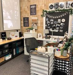 an office with many desks and chairs in front of a chalkboard on the wall