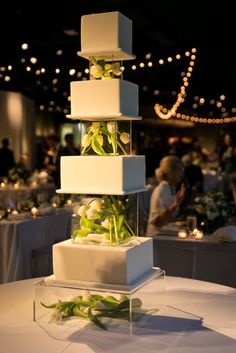 a tall white cake sitting on top of a table