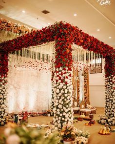 a decorated stage with red and white flowers