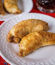 two croissants are on a white plate