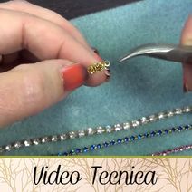 a woman is working on some beads with scissors