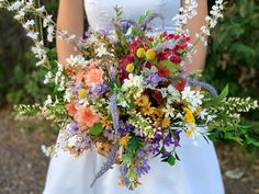 a bride holding a bouquet of flowers in her hands