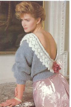 a woman is sitting on the floor in front of a mirror wearing a pink skirt