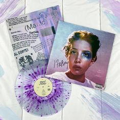 a purple and white tie - dyed record sitting on top of a table